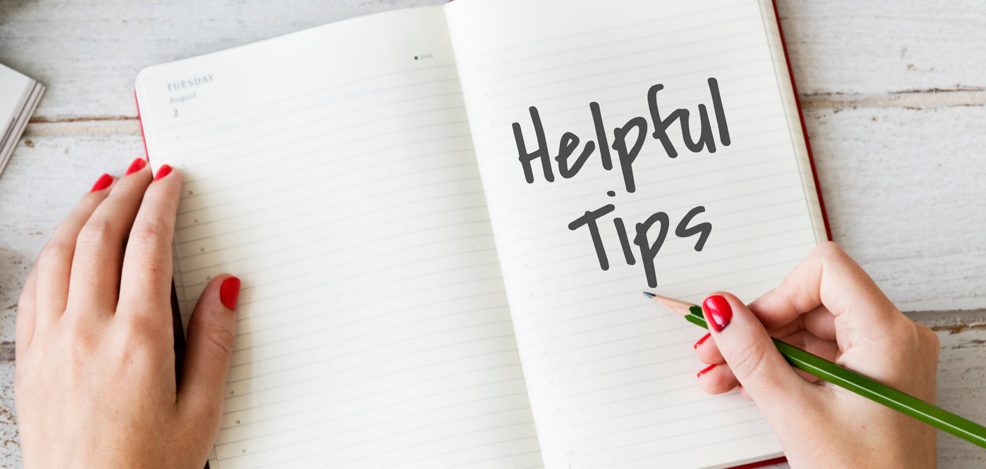 woman hand writing helpful tips on notepad