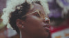 close-up of pretty african american women with yellow glasses and airplace earrings looking around